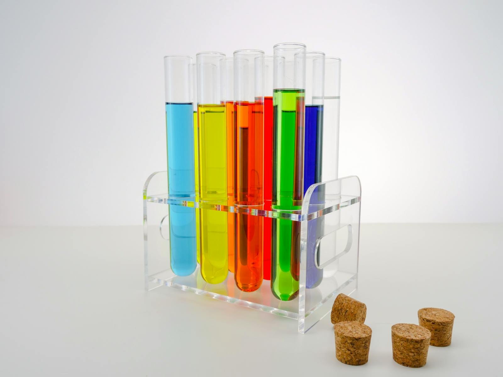 Colorful test tubes with various liquids in a laboratory setting, showcasing scientific research and experimentation.